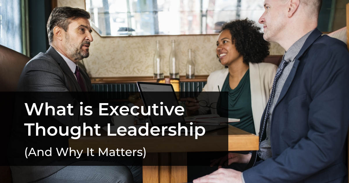 article banner featuring group of business professionals speaking around a table and article title What is Executive Thought Leadership (and Why it Matters)