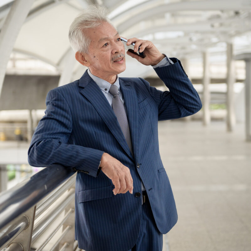 Will ChatGPT Write Social Media Posts For CEOs? article banner featuring older executive talking on phone