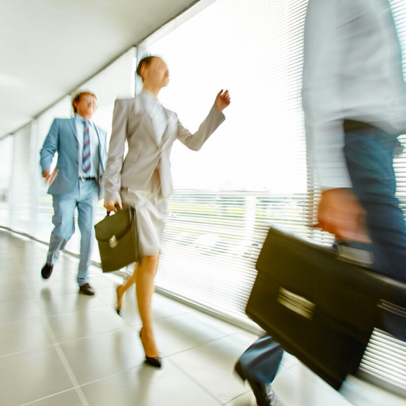 Accelerate Your Executive’s Online Influence featuring group of office workers walking quickly