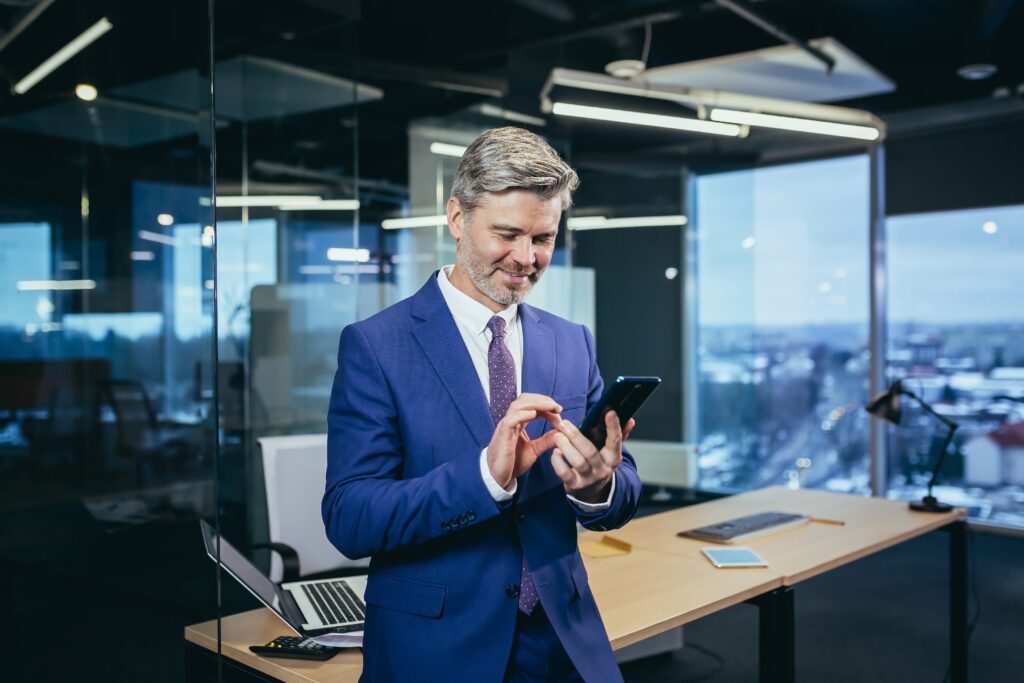 photo of business manager looking at social media on phone