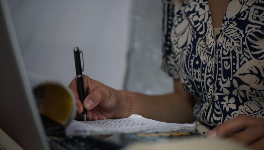 blog article image featuring close-up of woman writing in journal