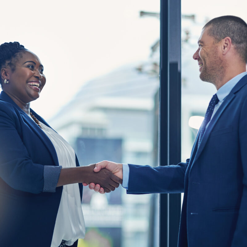 9 Ways To Support Your Executive’s Social Media Presence article banner featuring two business leaders giving each other a handshake